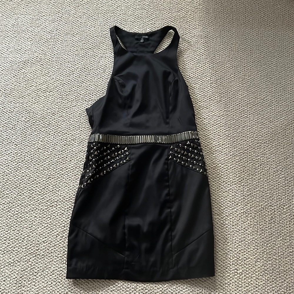 Halter dress with fabulous hardware front and back. Has side zipper and lining.
